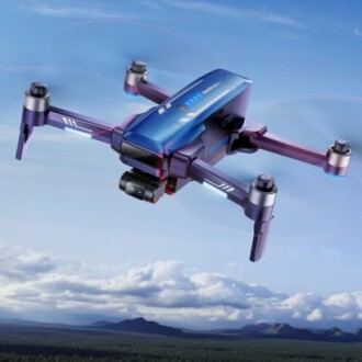 Blue drone flying over a scenic landscape with mountains in the background.